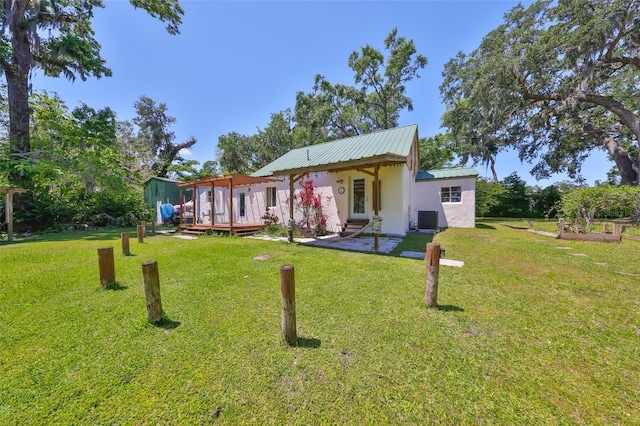 10824 Palmetto St, Riverview, FL 33569 - back of property with central air condition unit, stucco siding, and a lawn