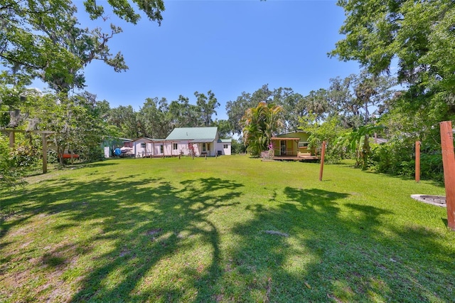 10824 Palmetto St, Riverview, FL 33569 - view of green lawn featuring a wooden deck