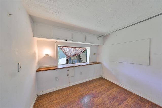 10824 Palmetto St, Riverview, FL 33569 - spare room featuring a textured ceiling, wood finished floors, and baseboards