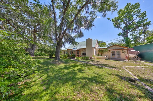 10824 Palmetto St, Riverview, FL 33569 - view of grassy yard featuring french doors
