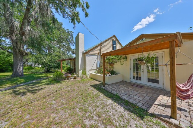 10824 Palmetto St, Riverview, FL 33569 - view of green lawn with a patio and french doors