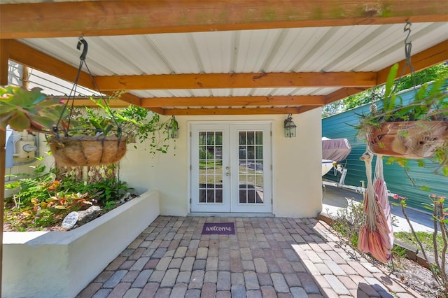 10824 Palmetto St, Riverview, FL 33569 - property entrance featuring french doors, stucco siding, and a patio area