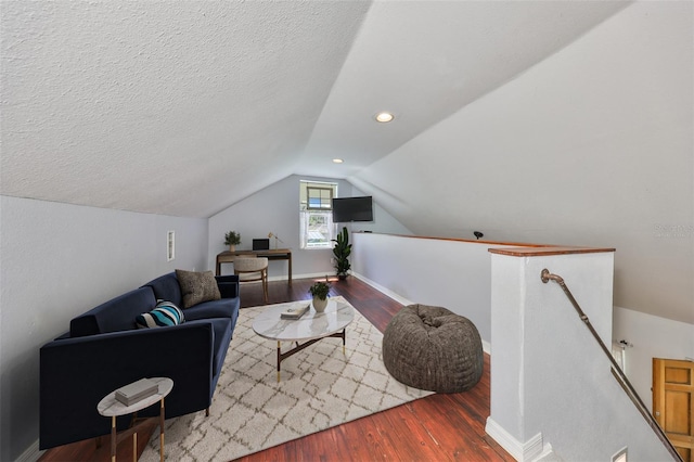 10824 Palmetto St, Riverview, FL 33569 - living area featuring wood finished floors, lofted ceiling, baseboards, and a textured ceiling