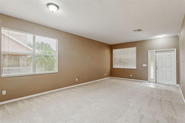 20606 Whitewood Way, Tampa, FL 33647 - unfurnished room featuring light carpet, a textured ceiling, and baseboards