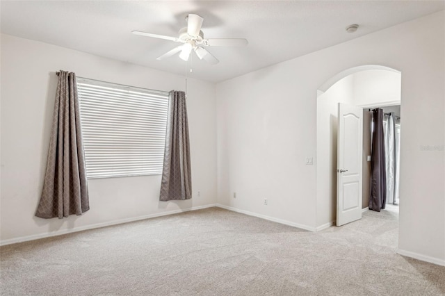 20606 Whitewood Way, Tampa, FL 33647 - spare room with light colored carpet, arched walkways, ceiling fan, baseboards, and a smoke detector