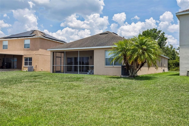 20606 Whitewood Way, Tampa, FL 33647 - back of property with stucco siding, a yard, central AC unit, and a sunroom