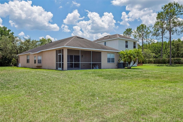 20606 Whitewood Way, Tampa, FL 33647 - rear view of house featuring a lawn, a sunroom, central AC unit, and stucco siding