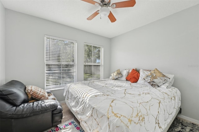 bedroom featuring baseboards and ceiling fan