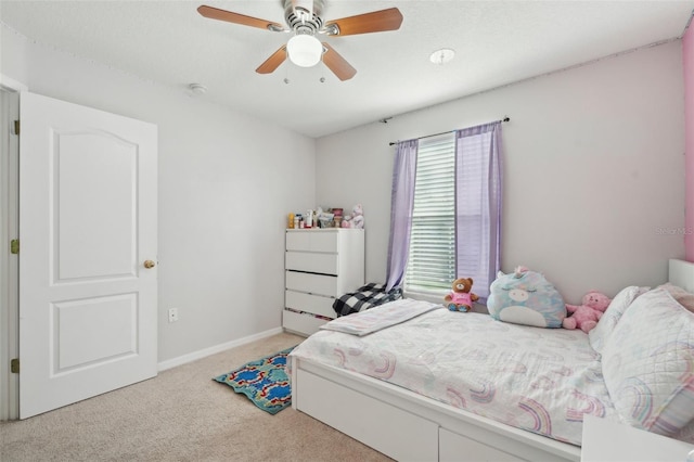 bedroom featuring baseboards, a ceiling fan, and light colored carpet