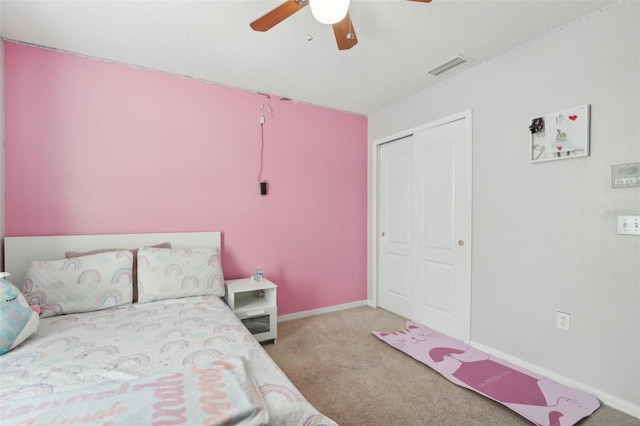 carpeted bedroom with baseboards, a ceiling fan, a closet, and visible vents