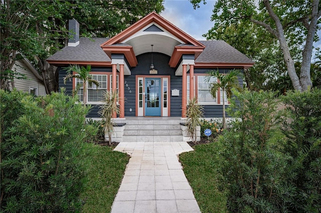 2536 Burlington Ave N, Saint Petersburg, FL 33713 - view of front of property featuring a shingled roof, a chimney, and a porch