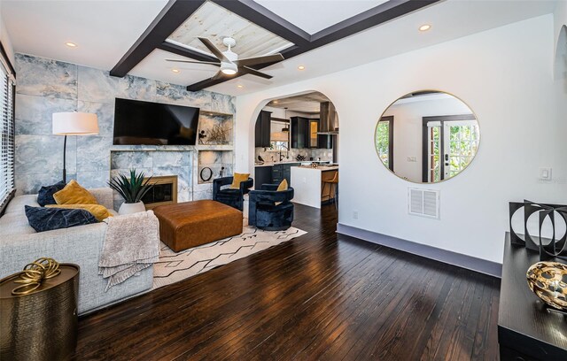 2536 Burlington Ave N, Saint Petersburg, FL 33713 - living room featuring a fireplace, a ceiling fan, baseboards, dark wood-type flooring, and visible vents
