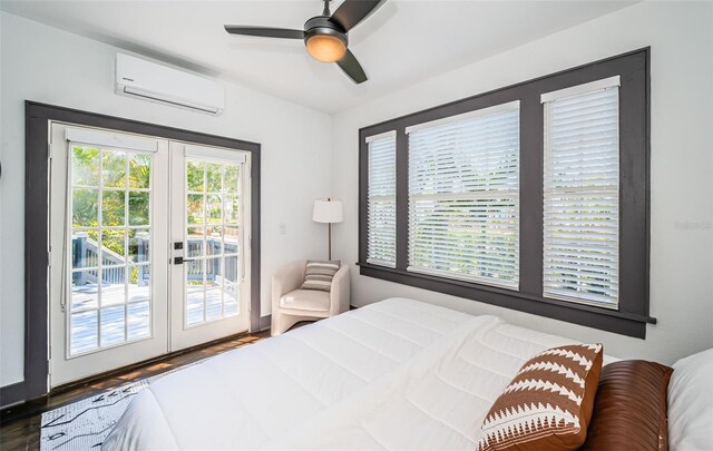2536 Burlington Ave N, Saint Petersburg, FL 33713 - bedroom featuring wood finished floors, access to exterior, a wall unit AC, french doors, and a ceiling fan