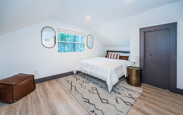 2536 Burlington Ave N, Saint Petersburg, FL 33713 - bedroom featuring baseboards, a closet, wood finished floors, and lofted ceiling
