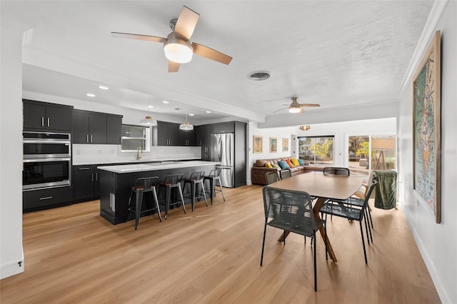 17730 Long Point Dr, Redington Shores, FL 33708 - dining room with recessed lighting, visible vents, a ceiling fan, light wood-type flooring, and crown molding