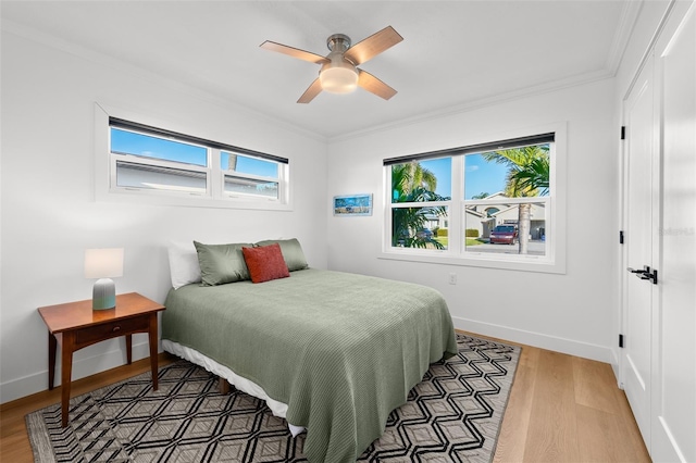 17730 Long Point Dr, Redington Shores, FL 33708 - bedroom featuring crown molding, multiple windows, and light wood-style flooring