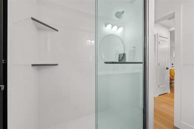 17730 Long Point Dr, Redington Shores, FL 33708 - full bathroom with visible vents, wood finished floors, and a tile shower