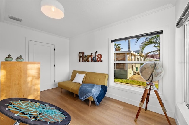 17730 Long Point Dr, Redington Shores, FL 33708 - sitting room featuring baseboards, ornamental molding, light wood finished floors, and visible vents