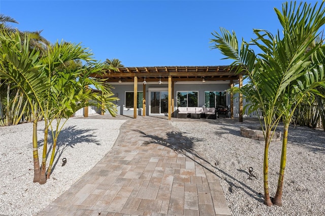 17730 Long Point Dr, Redington Shores, FL 33708 - rear view of property with stucco siding, a pergola, a patio, and an outdoor hangout area