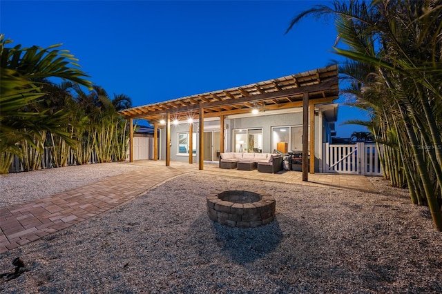 17730 Long Point Dr, Redington Shores, FL 33708 - back of house featuring a gate, a pergola, stucco siding, an outdoor living space with a fire pit, and a patio