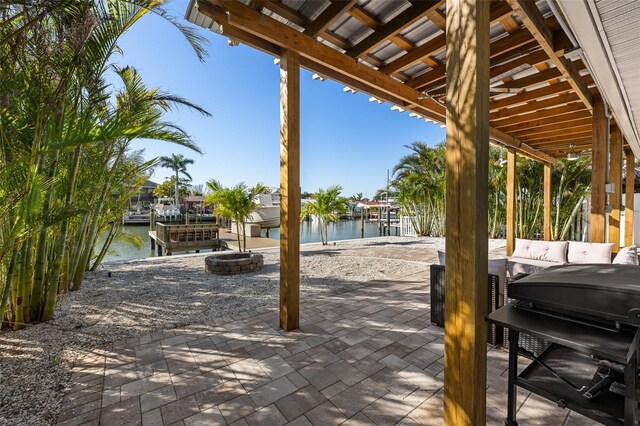 17730 Long Point Dr, Redington Shores, FL 33708 - view of patio with boat lift, a grill, a water view, and a dock