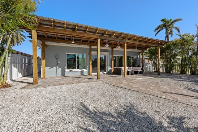 17730 Long Point Dr, Redington Shores, FL 33708 - rear view of house with a pergola, an outdoor living space, a ceiling fan, a patio, and stucco siding