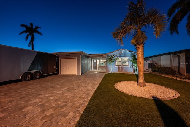 17730 Long Point Dr, Redington Shores, FL 33708 - exterior space with central AC unit, decorative driveway, and a garage