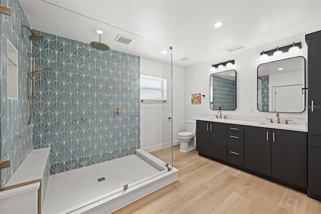 17730 Long Point Dr, Redington Shores, FL 33708 - bathroom with wood finished floors, visible vents, tiled shower, and a sink