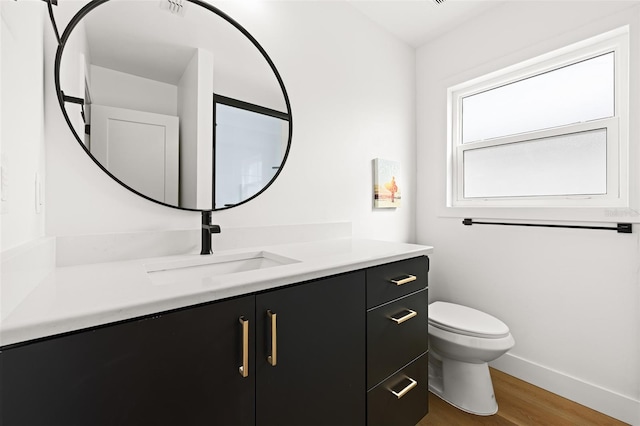 17730 Long Point Dr, Redington Shores, FL 33708 - bathroom with baseboards, wood finished floors, vanity, and toilet