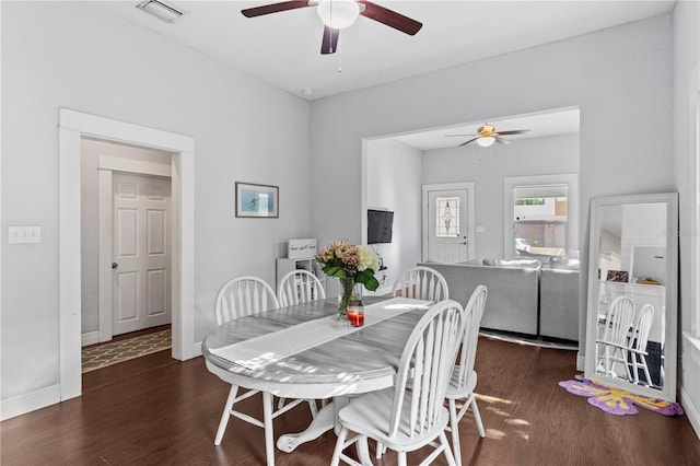 dining room featuring baseboards, visible vents, wood finished floors, and ceiling fan