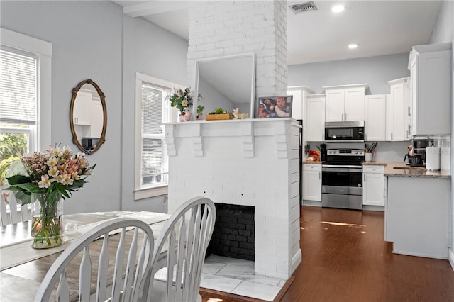 kitchen featuring white cabinetry, visible vents, stainless steel appliances, recessed lighting, and dark wood finished floors