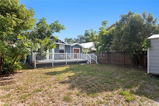 view of yard with fence and a wooden deck