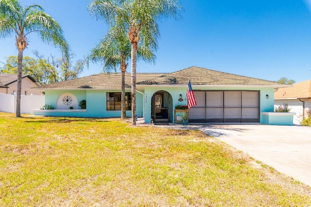 2435 Comerwood Dr, Spring Hill, FL 34609 - single story home with fence, a front lawn, stucco siding, driveway, and a garage