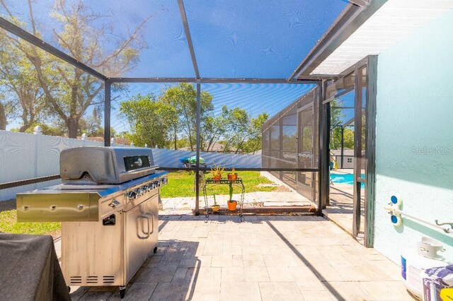 2435 Comerwood Dr, Spring Hill, FL 34609 - view of patio with glass enclosure, a pool, and a fenced backyard