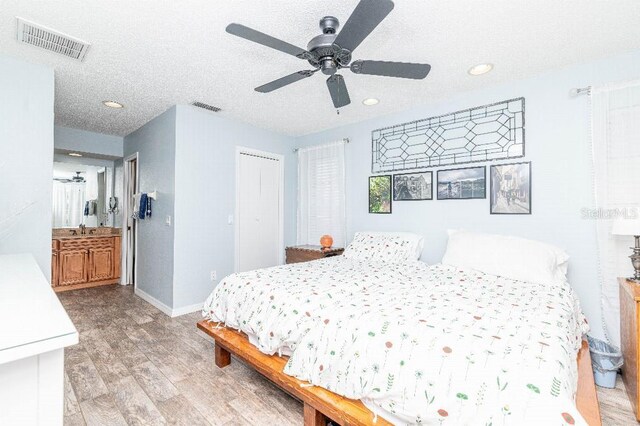 2435 Comerwood Dr, Spring Hill, FL 34609 - bedroom featuring recessed lighting, visible vents, light wood finished floors, and baseboards