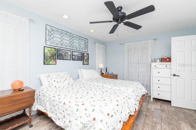 2435 Comerwood Dr, Spring Hill, FL 34609 - bedroom featuring wood finished floors, recessed lighting, a textured ceiling, and ceiling fan