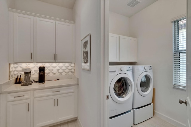 17583 Holly Well Ave, Wimauma, FL 33598 - laundry area with washer and dryer, baseboards, cabinet space, and visible vents