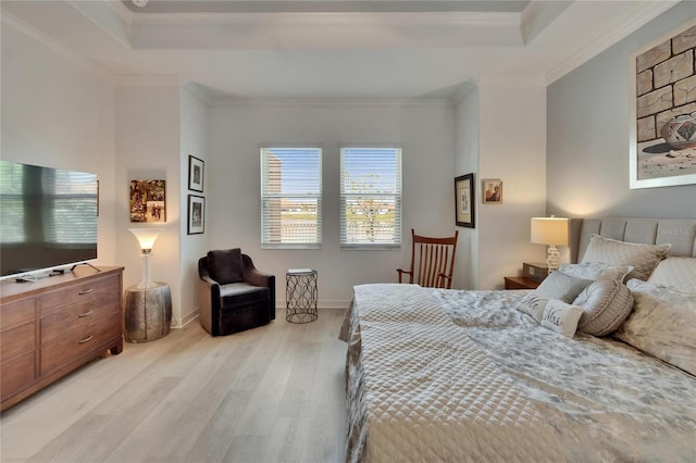 17583 Holly Well Ave, Wimauma, FL 33598 - bedroom with crown molding, a tray ceiling, and light wood-type flooring