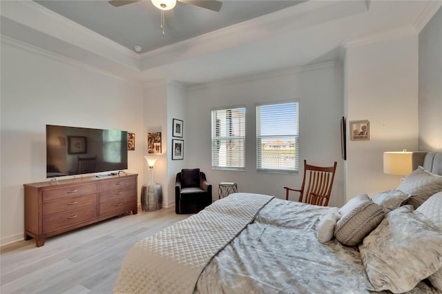17583 Holly Well Ave, Wimauma, FL 33598 - bedroom with light wood-style flooring, a tray ceiling, baseboards, a ceiling fan, and crown molding