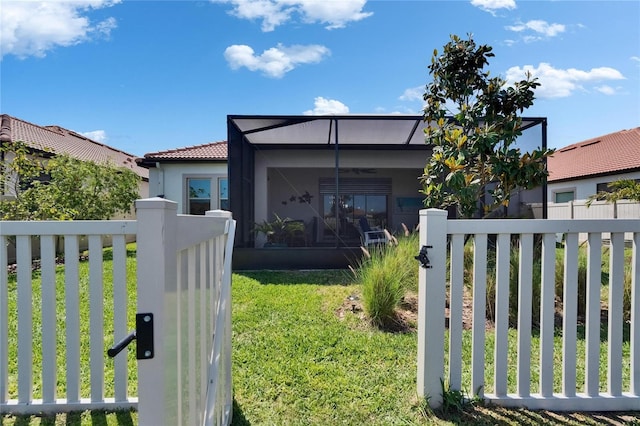 17583 Holly Well Ave, Wimauma, FL 33598 - view of front facade with a tile roof, a lanai, fence, a front yard, and stucco siding