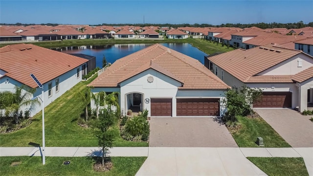 17583 Holly Well Ave, Wimauma, FL 33598 - mediterranean / spanish-style home with a residential view, a tile roof, a water view, driveway, and a garage