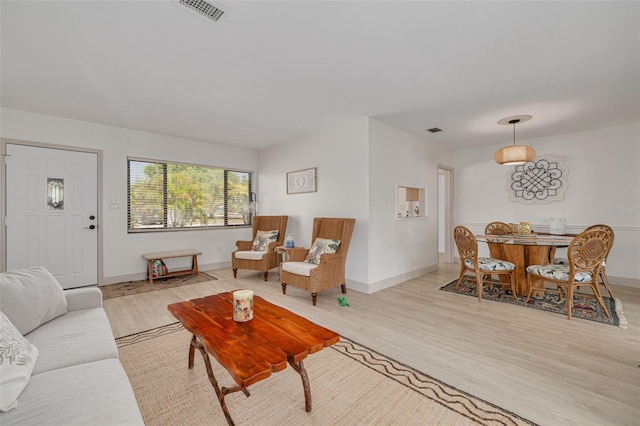 225 Cevera Dr, Dunedin, FL 34698 - living room with baseboards, wood finished floors, and visible vents