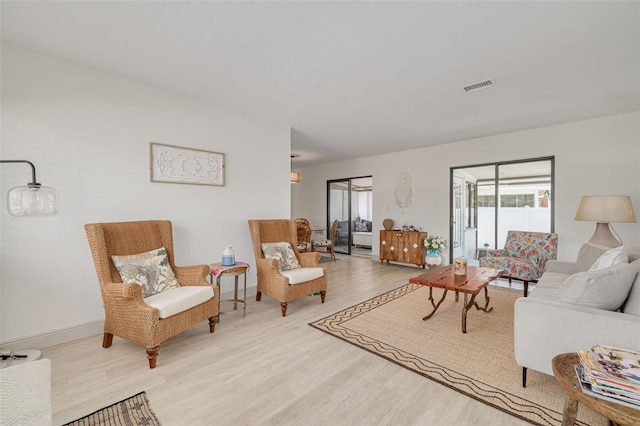 225 Cevera Dr, Dunedin, FL 34698 - living area with baseboards, wood finished floors, and visible vents