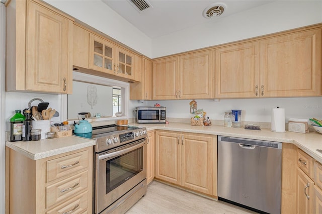 225 Cevera Dr, Dunedin, FL 34698 - kitchen with light brown cabinets, stainless steel appliances, and visible vents