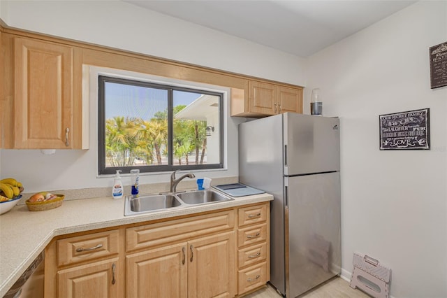 225 Cevera Dr, Dunedin, FL 34698 - kitchen with stainless steel appliances, light countertops, light brown cabinetry, and a sink