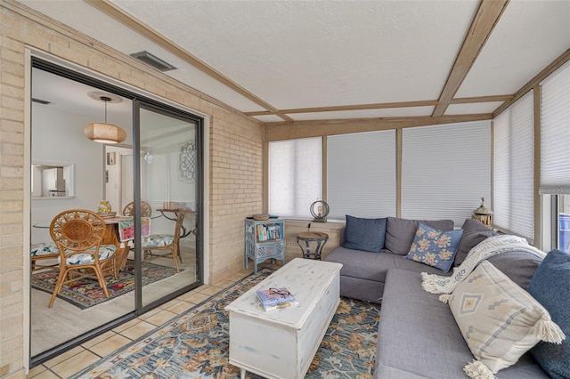 225 Cevera Dr, Dunedin, FL 34698 - tiled living area featuring brick wall and visible vents