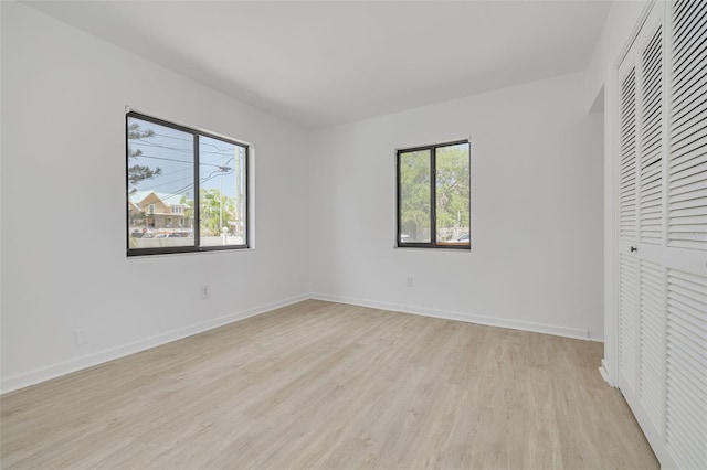 225 Cevera Dr, Dunedin, FL 34698 - unfurnished bedroom with baseboards, a closet, and light wood-type flooring