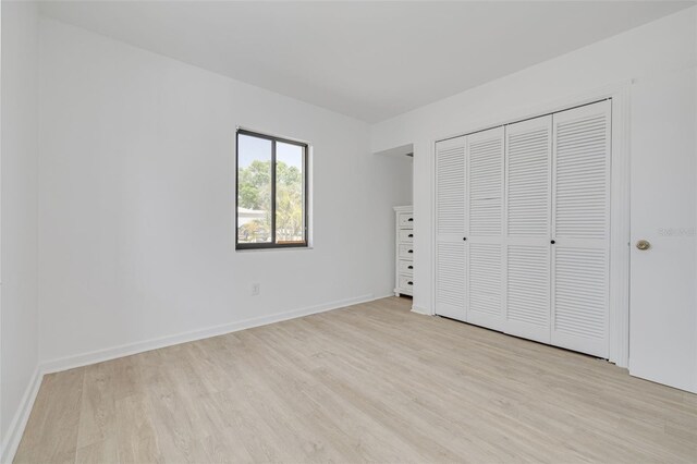 225 Cevera Dr, Dunedin, FL 34698 - unfurnished bedroom with wood finished floors, a closet, and baseboards