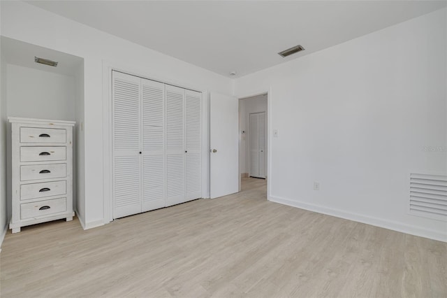 225 Cevera Dr, Dunedin, FL 34698 - unfurnished bedroom with baseboards, visible vents, light wood-style floors, and a closet