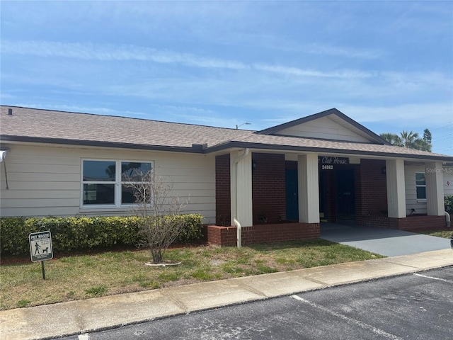 24862 US Highway 19 N Unit 2303, Clearwater, FL 33763 - single story home with brick siding, a porch, roof with shingles, and a front lawn